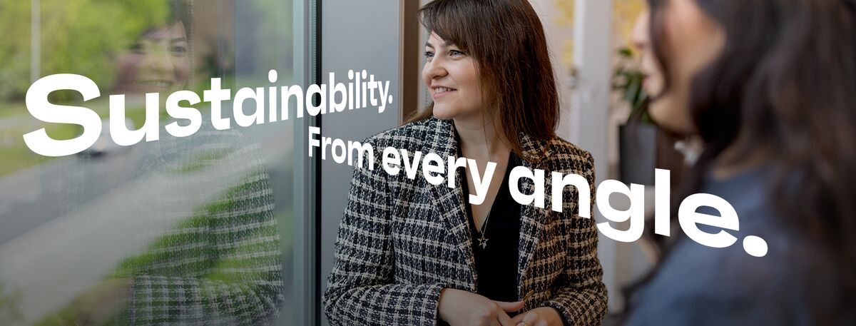 Two women looking out of office window.