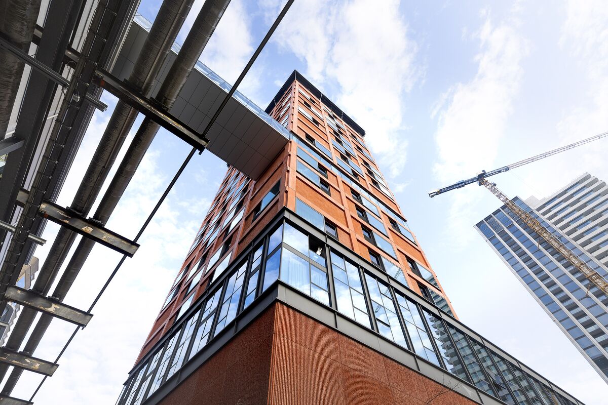 Angled view of orange high-rise building.