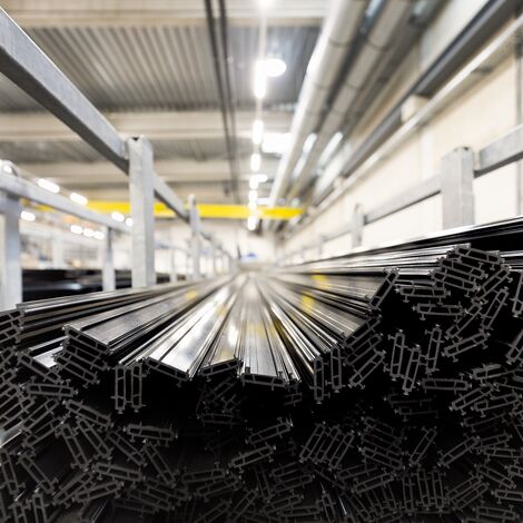 Black thermal strips stacked in iron chassis in warehouse.