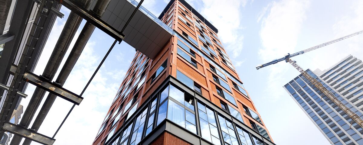 Orange high-rise building looked from below.