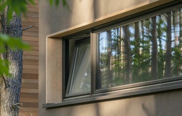 Turn-tilt window in private Polish home, with tree on the side.