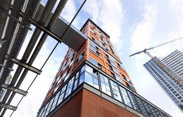 Orange high-rise building looked from below.